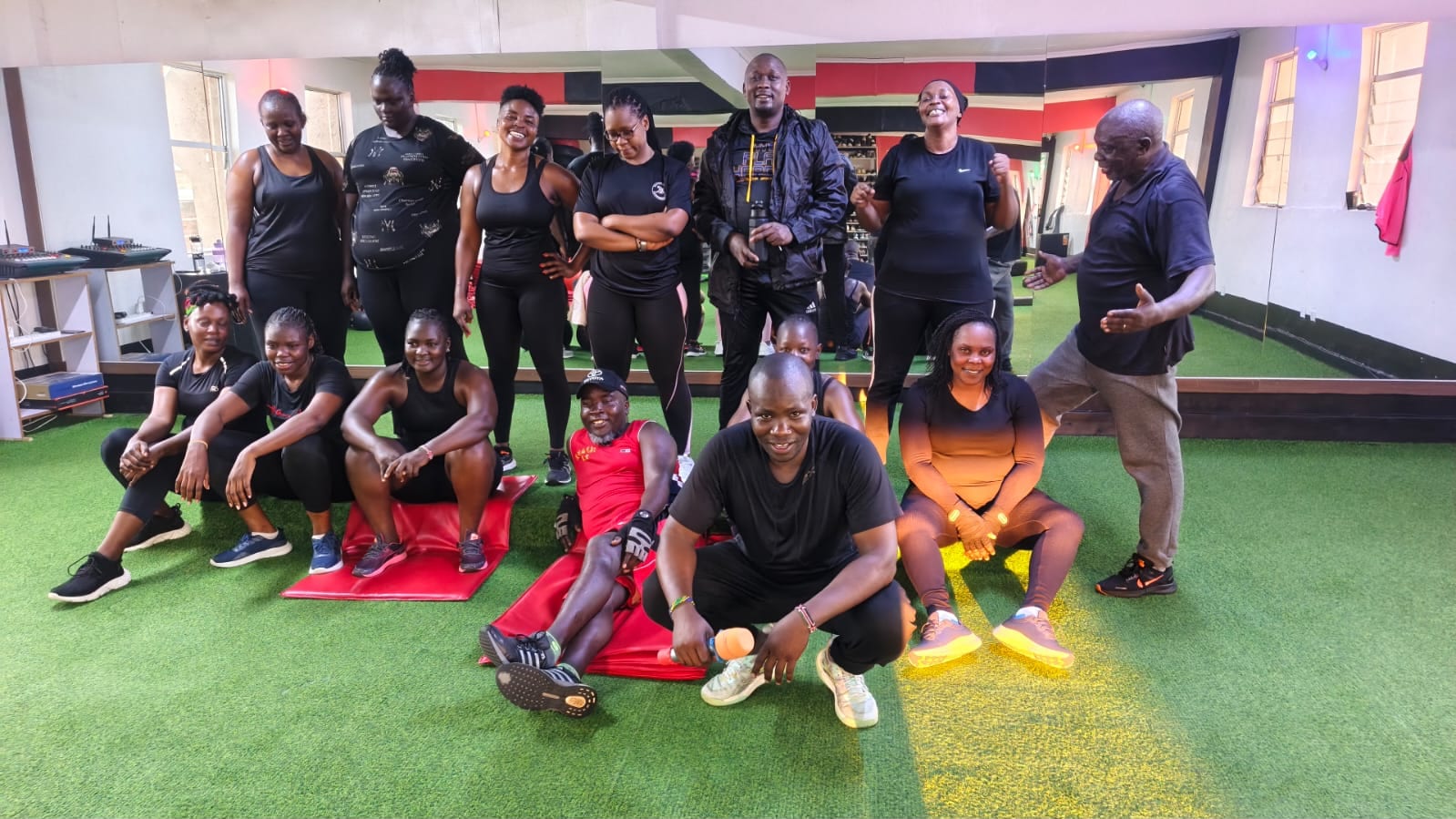 Members on the turf floor at the end of a mat session
